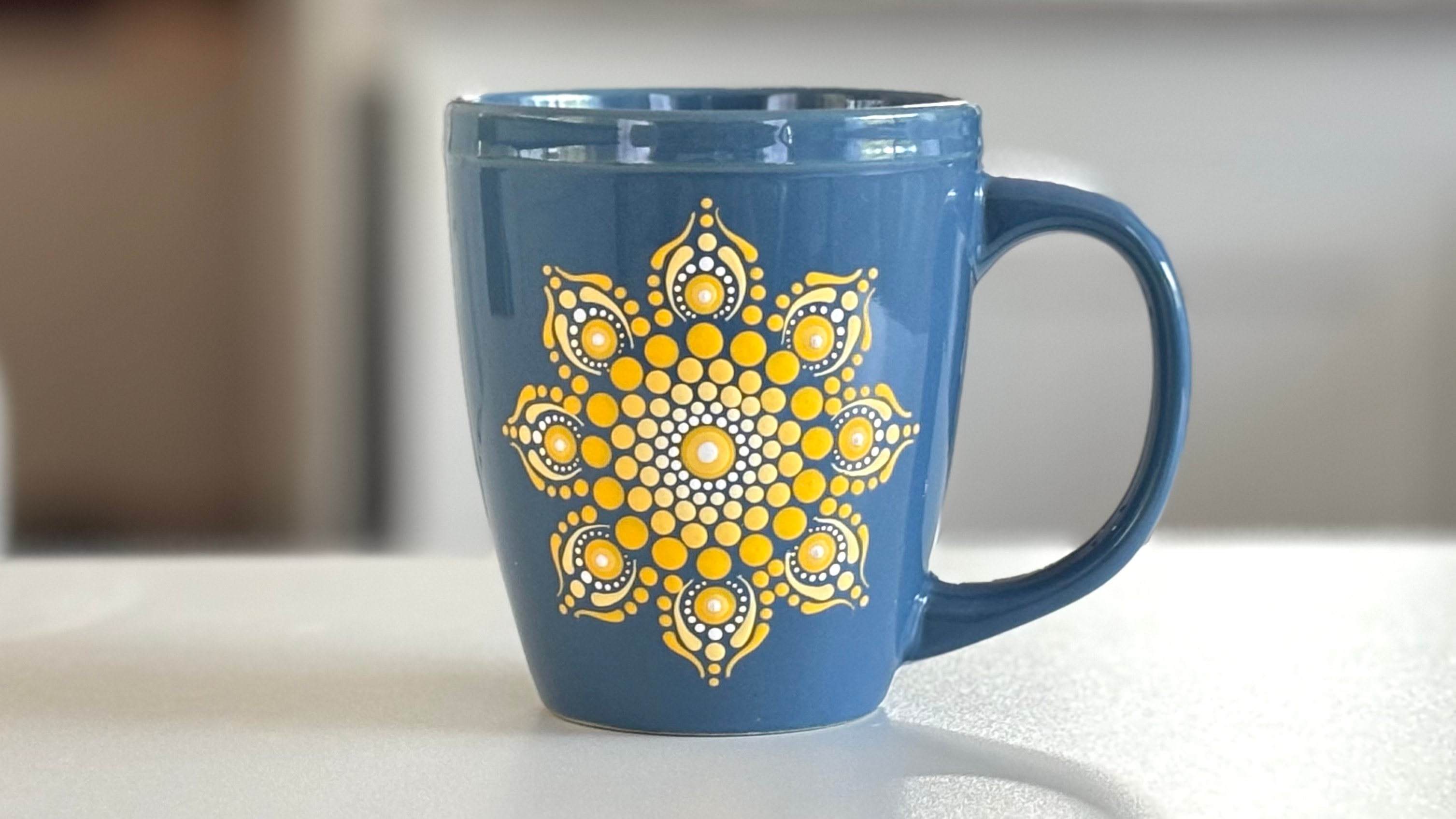 Blue mug with gold mandala dot design